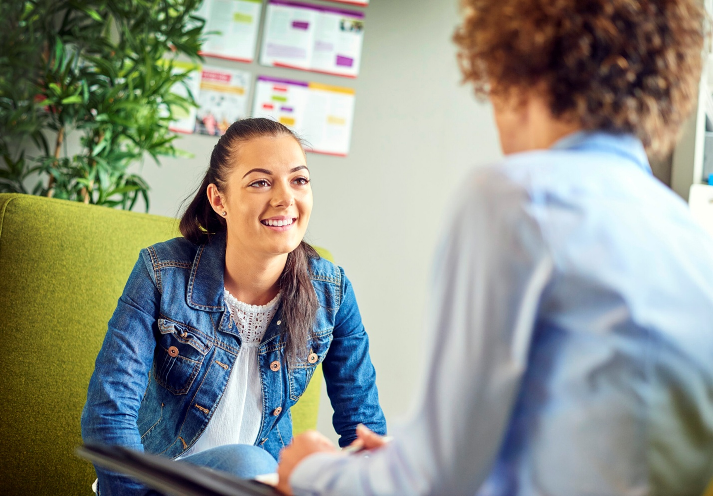 Photograph of two people engaged in a conversation in an office setting